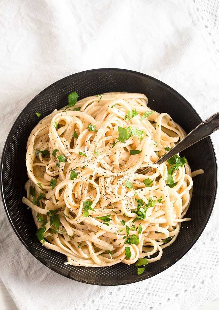 bowl of pasta on a white table cloth.