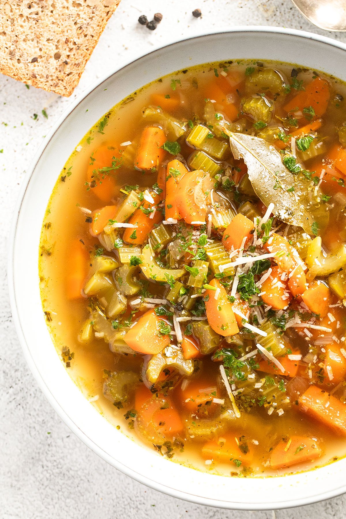 close up of celery and carrot soup in a bowl.