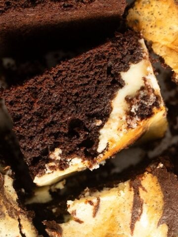 close up sweetened condensed milk brownie with cream cheese topping.