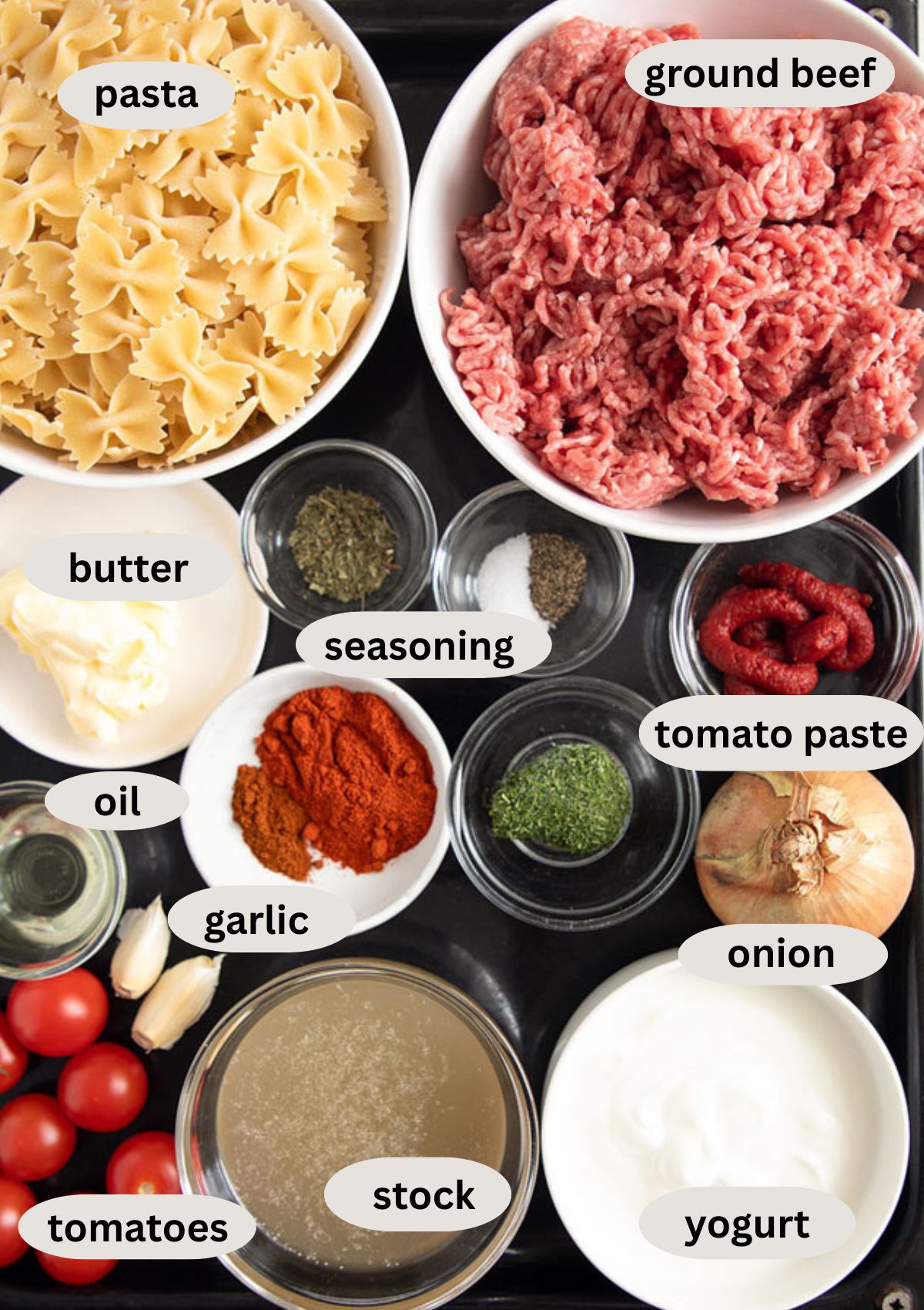 listed ingredients for making turkish pasta with ground beef, farfale, yogurt, and tomatoes.
