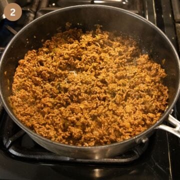 cooking ground beef for making pasta sauce in a large saucepan.