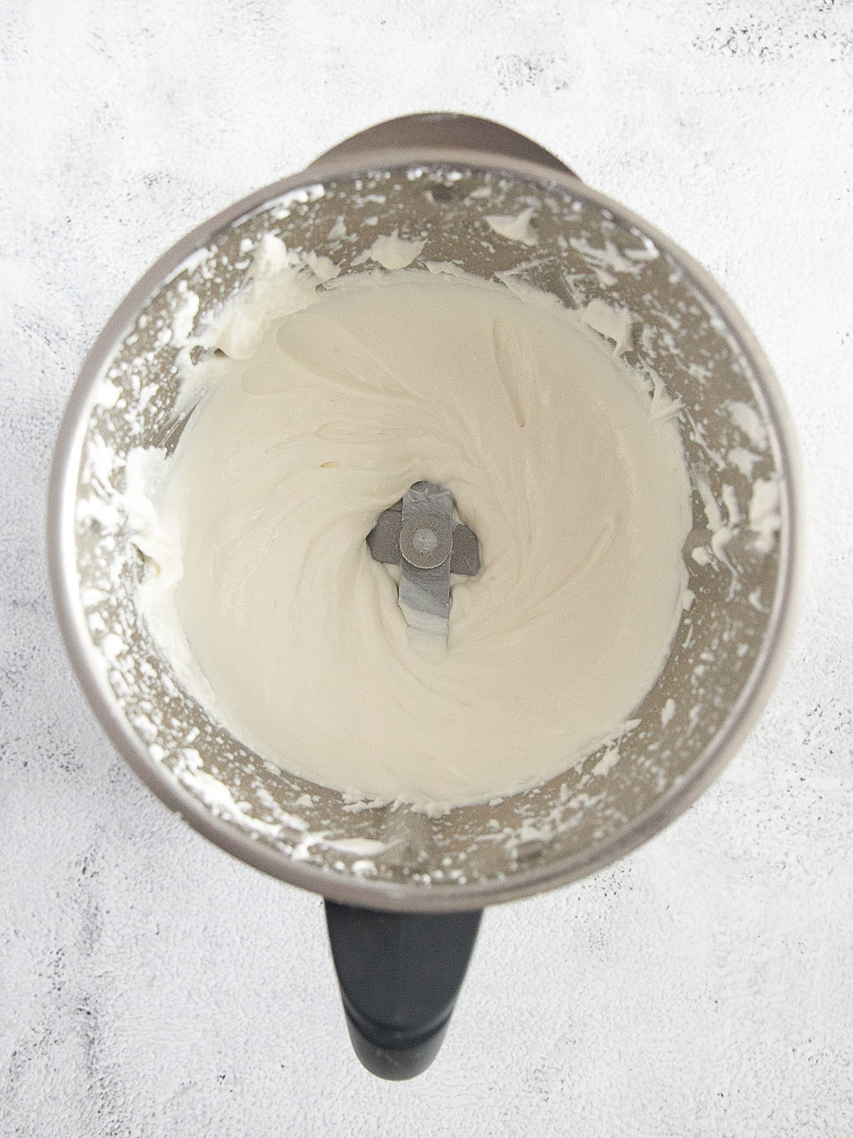 blending cottage cheese in a large food processor.