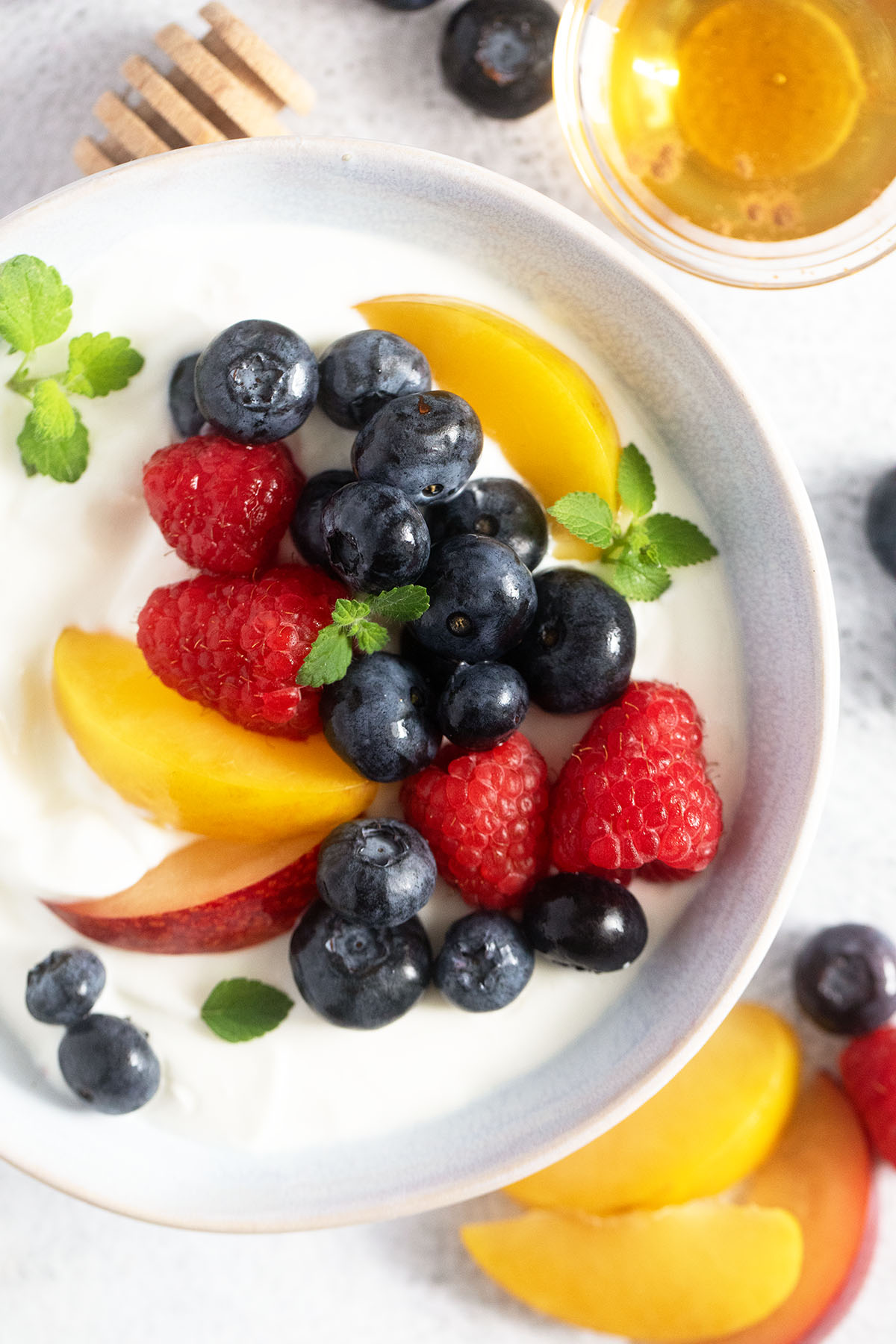 close up of a bowl with blended cottage cheese topped with fresh fruit.