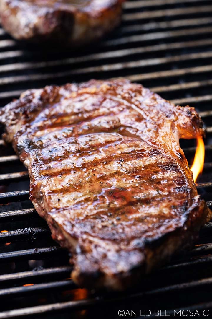 a juicy grilled ribeye steak that goes well with mac and cheese for dinner.