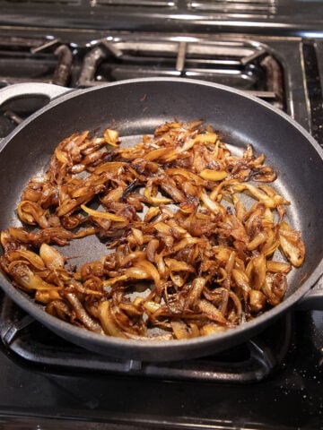 caramelized onions in a large skillet on the stove top.