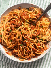spaghetti with ground turkey tangled in a bowl, a fork sticking in it.