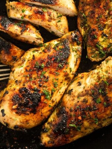 four garlic and herb chicken breasts, one sliced.