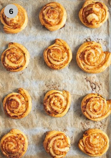 baked puff pastry pinwheels on a baking sheet.