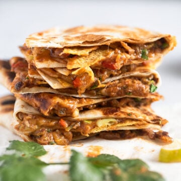 stack of refried bean quesadillas with cheese.