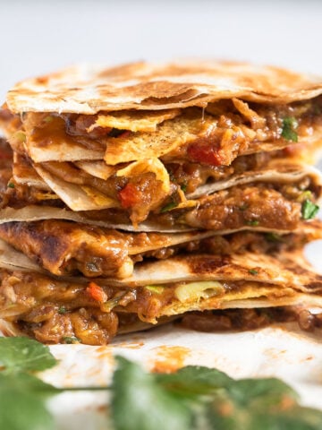 stack of refried bean quesadillas with cheese.