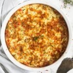 quiche with cottage cheese in a round large ceramic baking dish.