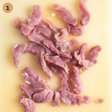 raw pork tenderloin cut into strips.