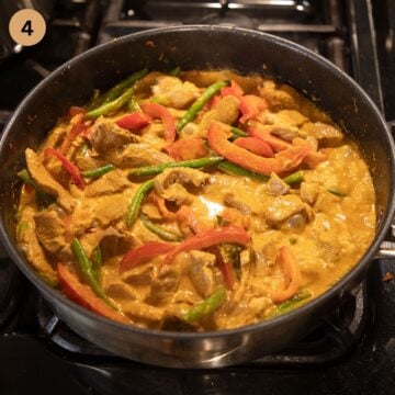 vegetables simmering in coconut milk and red curry paste sauce.