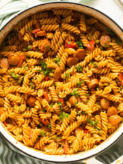 creamy hot dog pasta sprinkled with parsley in a large dutch oven.