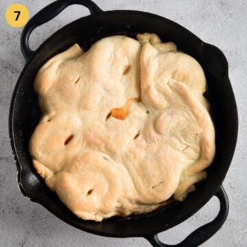 freshyl baked tarte tatin with peaches and puff pastry in a skillet.