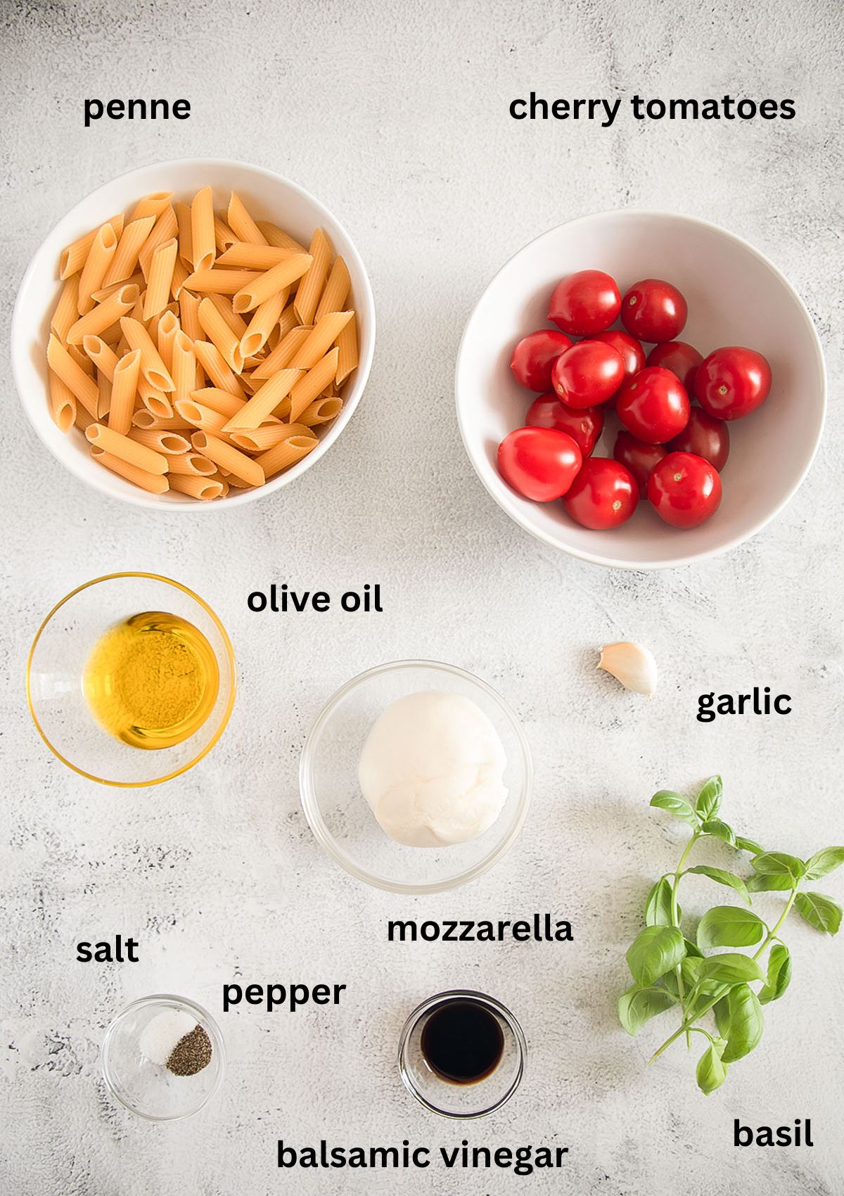 listed ingredients for making penne with tomatoes, mozzarella, basil, olive oil, garlic and balsamic.