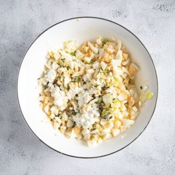 bowl with chopped ingredients for making egg salad.