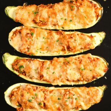 golden baked zucchini stuffed with rice and topped with mozzarella cheese.