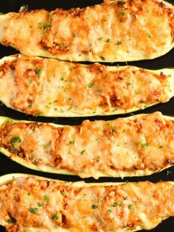 golden baked zucchini stuffed with rice and topped with mozzarella cheese.