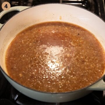 making sauce for turkey in a large dutch oven on the stovetop.