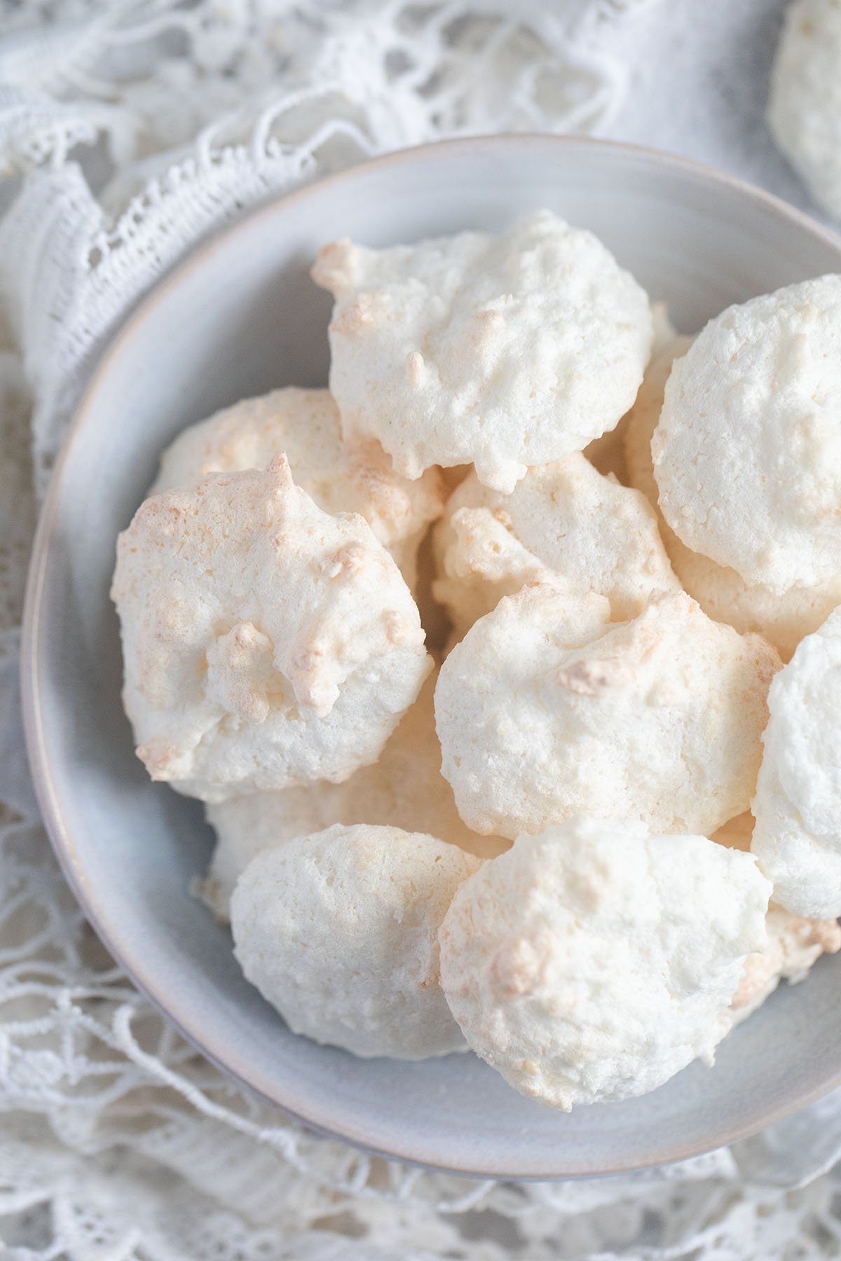 round and white coconut macaroons in a small bowl.