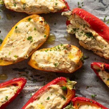 red and yellow cream cheese stuffed peppers sprinkled with parsley.