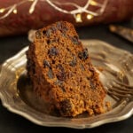 thick slice of pineapple fruitcake on a vintage plate.