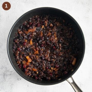 mixture of crushed pineapple and dried fruit in a saucepan.