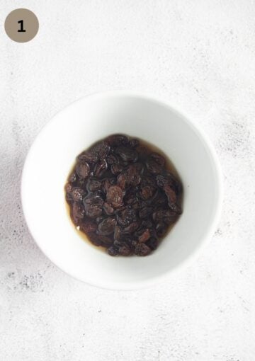 raisins soaking in amaretto in a small bowl.