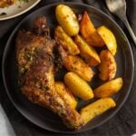 air fryer chicken quarters served with potato wedges.