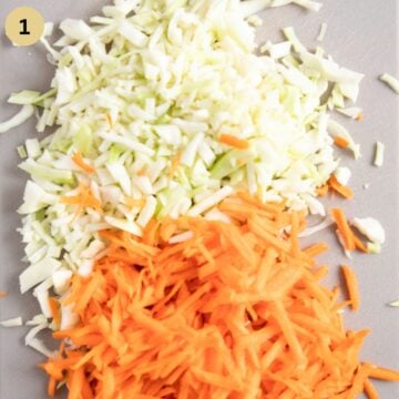 finely chopped white cabbage and grated carrots on a cutting board.