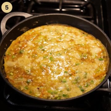 still runny omelett with cabbage and eggs in a pan.