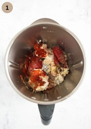 the ingredients for pepper feta dip in a food processor before blending.