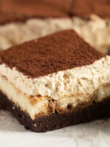 creamy tiramisu brownies dusted with cocoa powder.