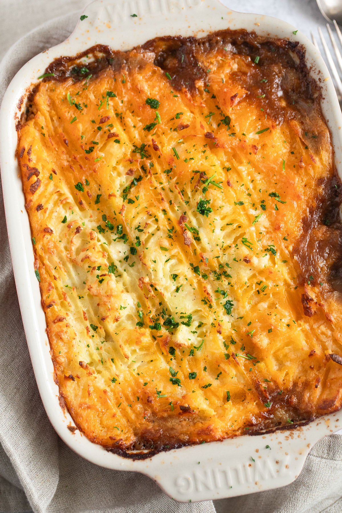 a baking dish with golden brown guinness cottage pie.