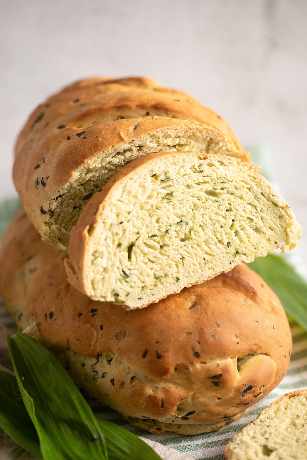 two stapled loaves of wild garlic bread, one showing the crumb.