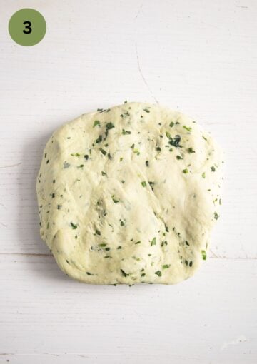 bread dough flattened into a square on the working surface.