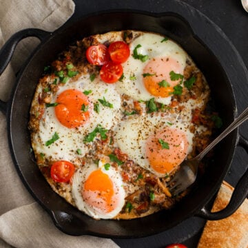 fisherman's eggs sprinkled with parsley in a cast iron skillet.