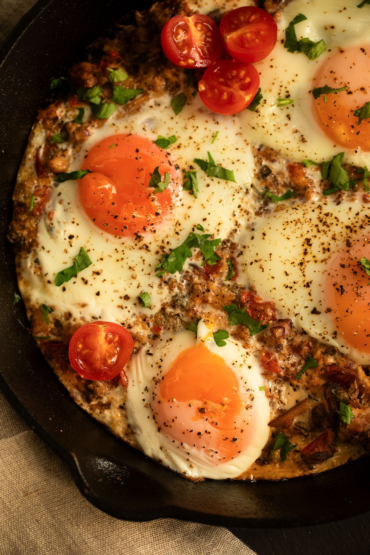 baked fisherman's eggs with sardines served with small tomatoes.