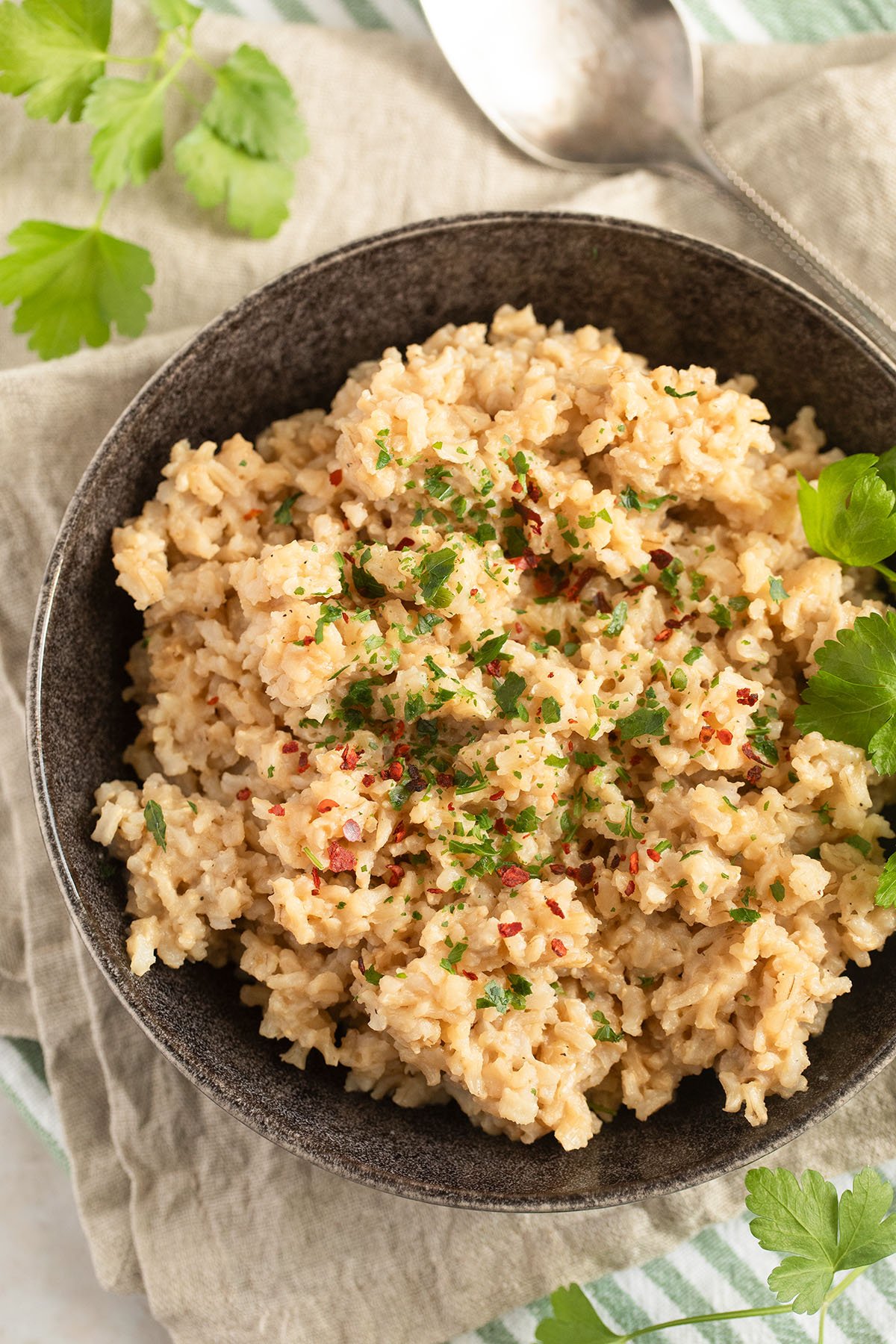 a bowl full of miso brown rice garnished with fresh cilantro leaves.