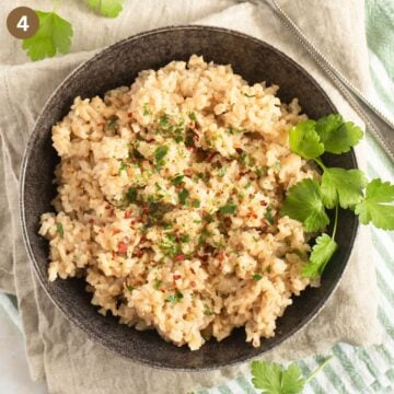 brown rice with miso and cilantro in a black bowl.