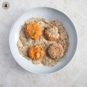 coating sweet potato and shrimp cakes with breadcrumbs and sesame seed mixture.
