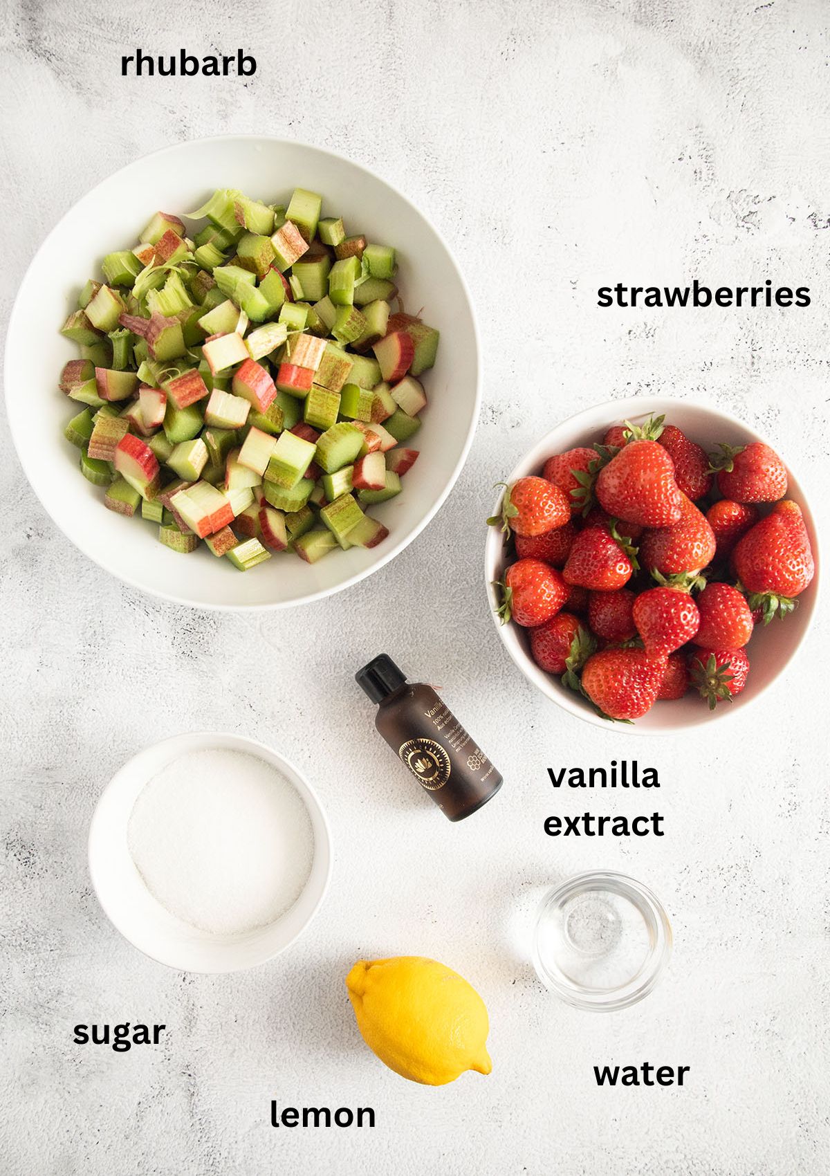 labeled ingredients for making compote with strawberries, rhubarb, sugar, lemon and vanilla.