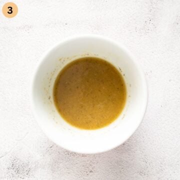 dressing for potato salad in a small bowl.