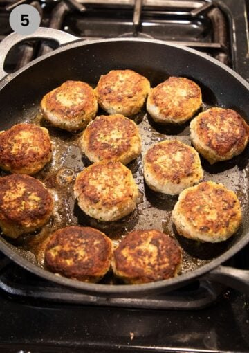 browning many meatballs in a large frying pan.
