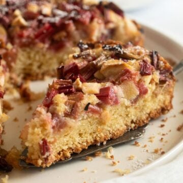 a slice of apple and rhubarb cake on a platter.