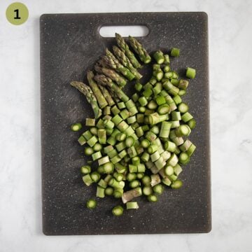 chopped asparagus on a cutting board.