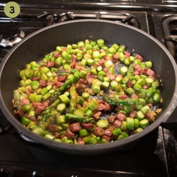 sauteing chopped asparagus and pancetta in a large skillet.
