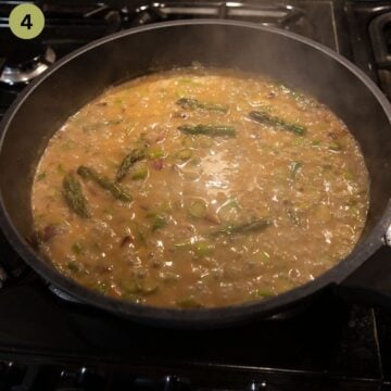 simmering asparagus and pea sauce for pasta in a skillet.