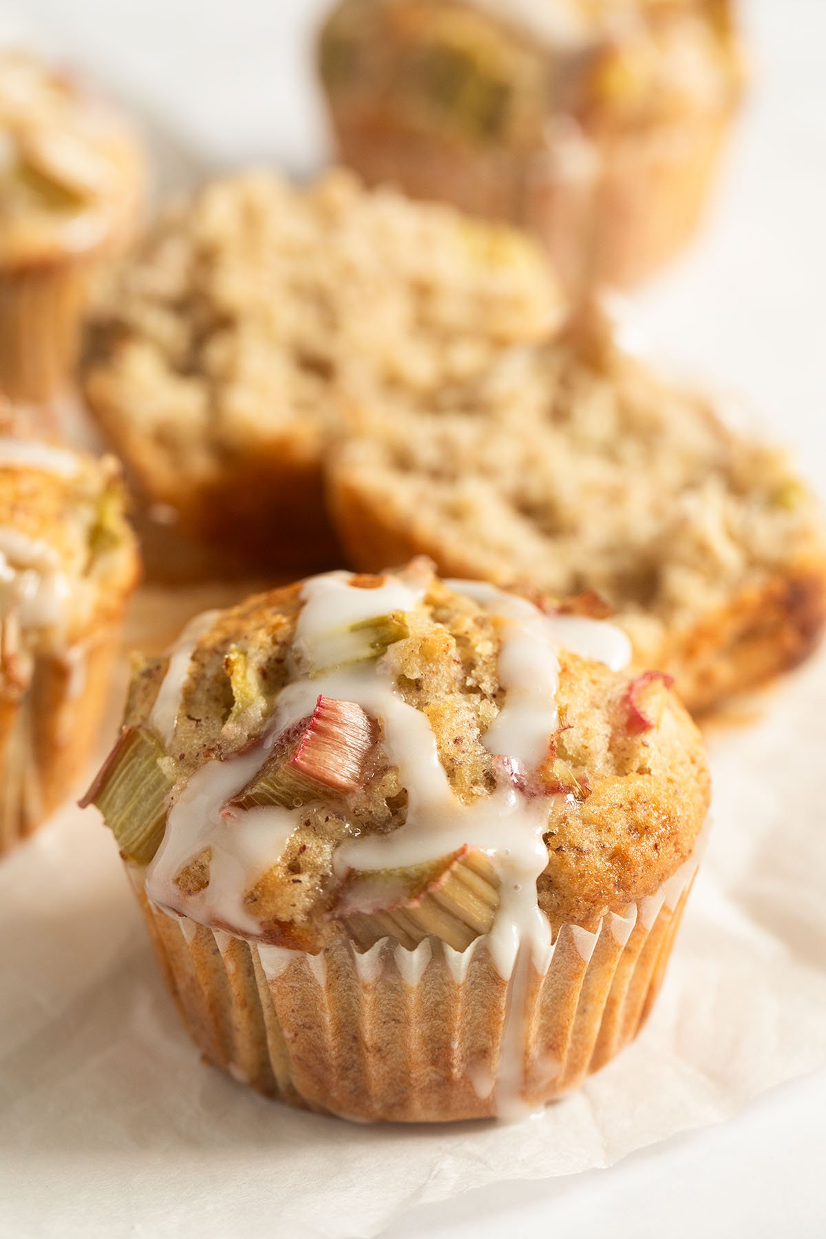 rhubarb and banana muffins, one split to show the crumb.